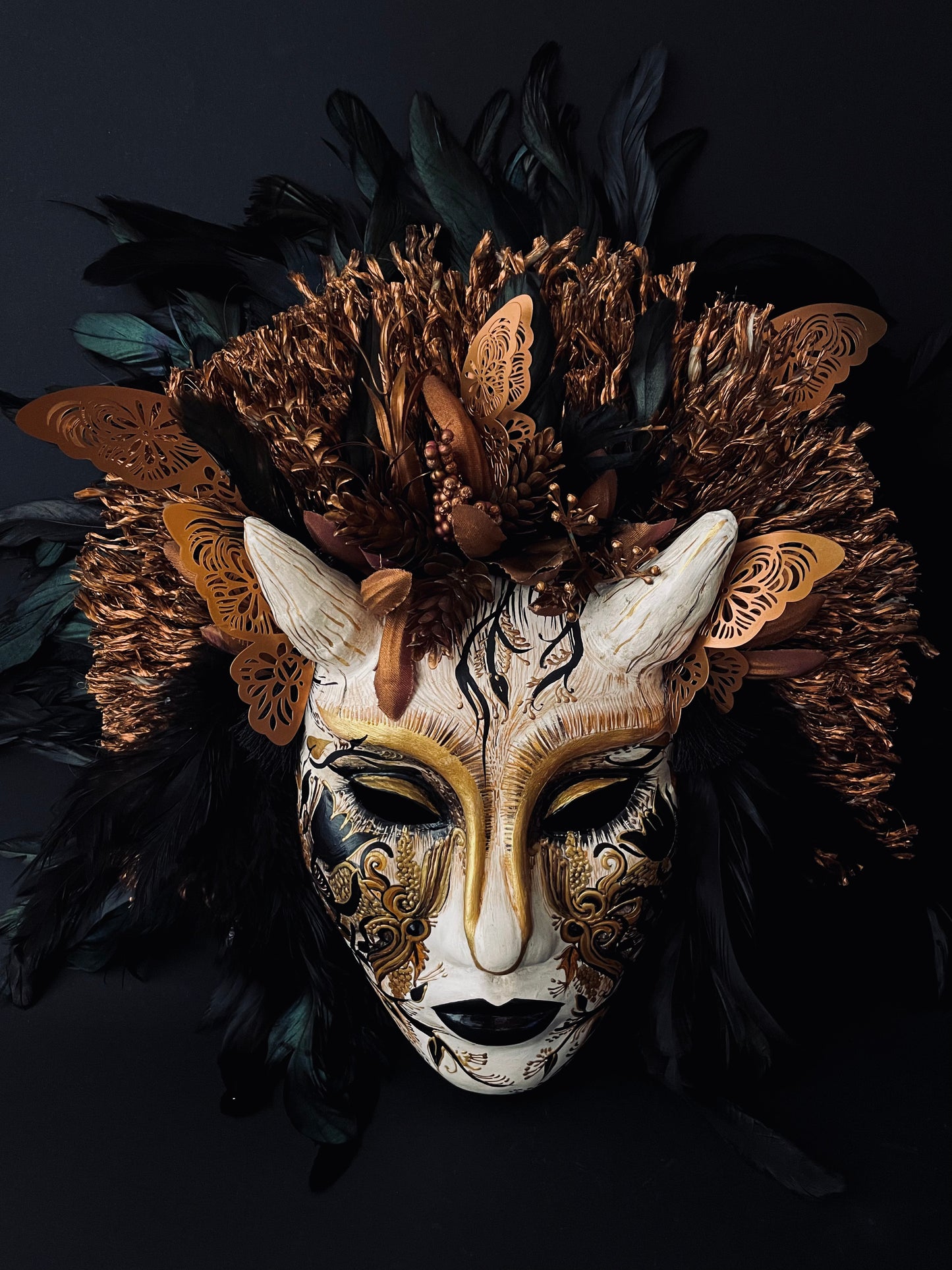 Demon mask with feathers. Masquerade mask