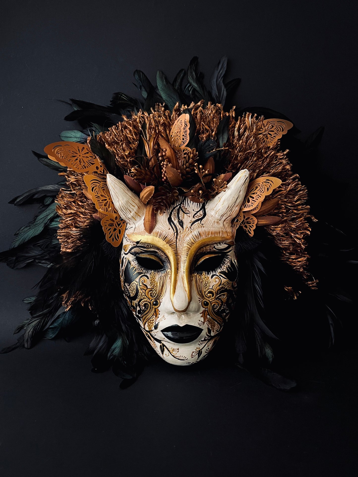 Demon mask with feathers. Masquerade mask