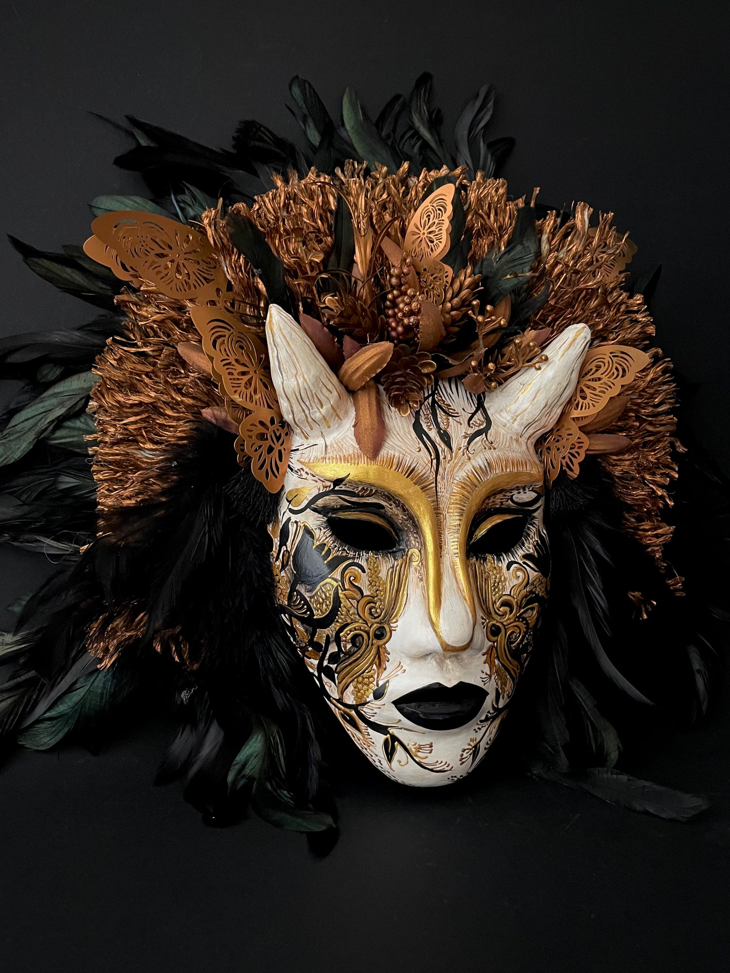 Demon mask with feathers. Masquerade mask
