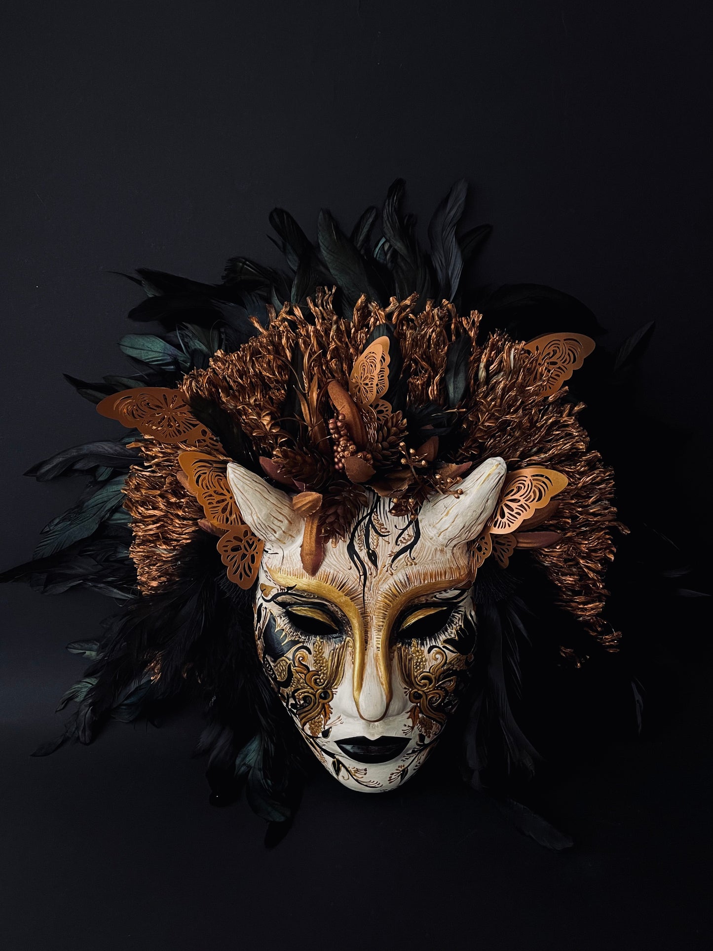 Demon mask with feathers. Masquerade mask