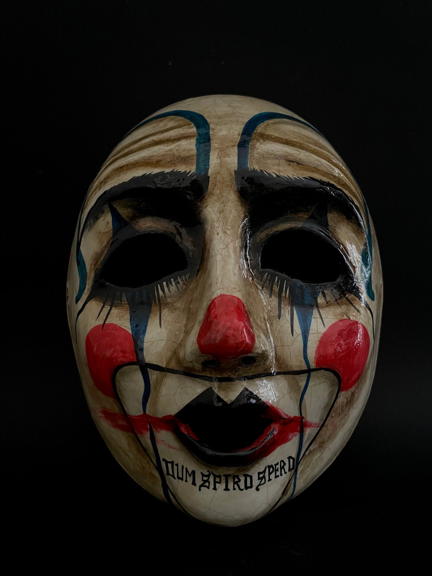 Sad clown mask.