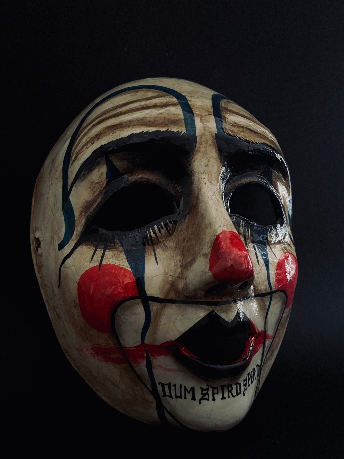 Sad clown mask.