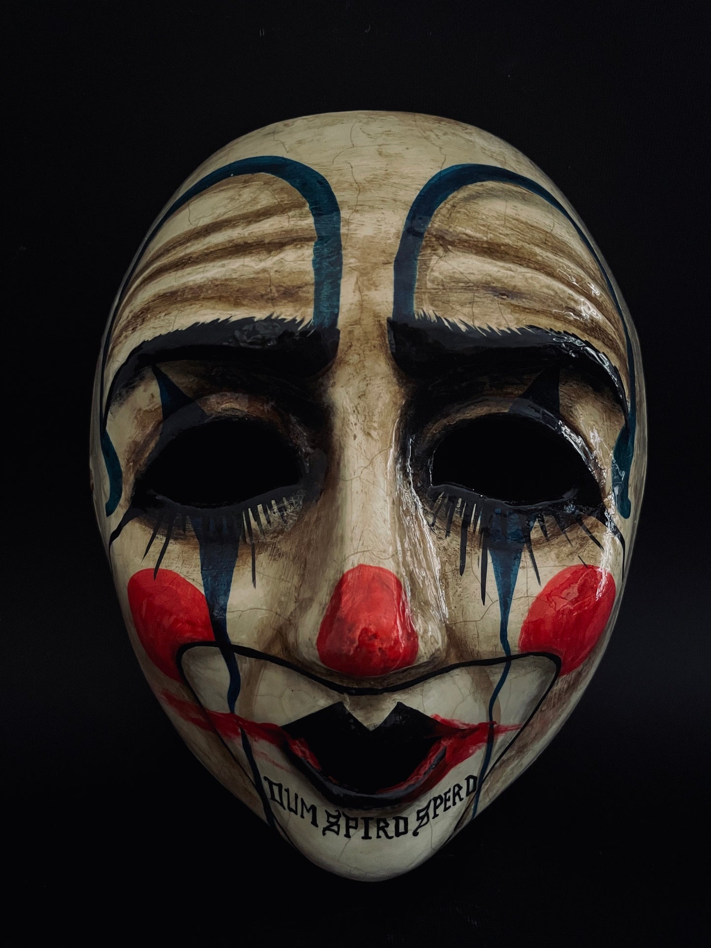 Sad clown mask.