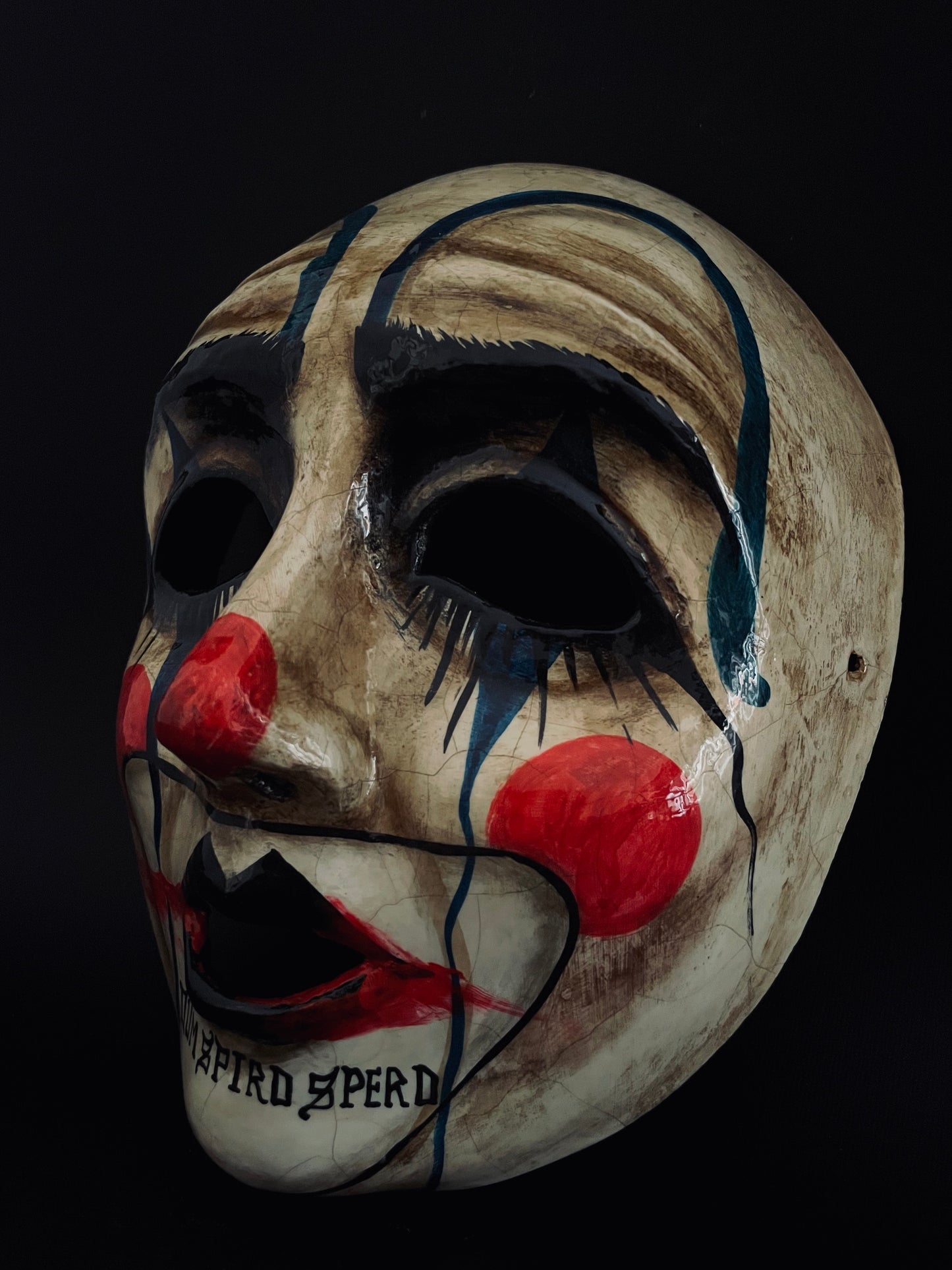 Sad clown mask.