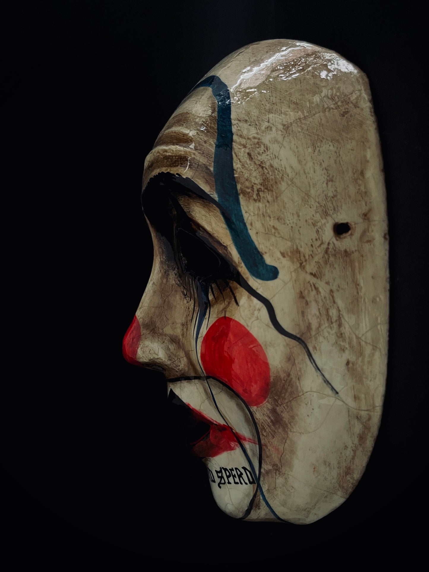 Sad clown mask.