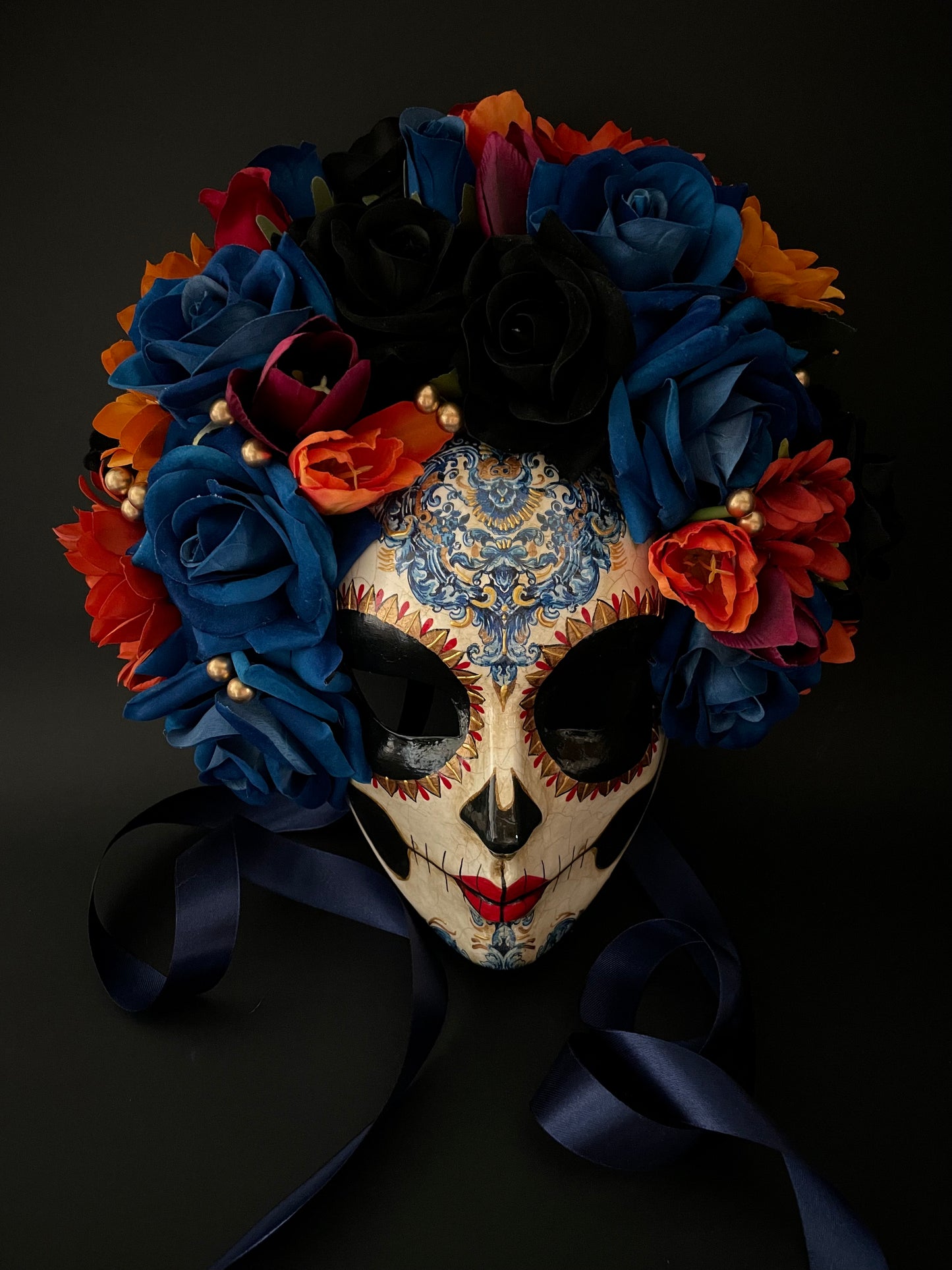 Catrina with blue and orange flowers. Day of the dead mask.