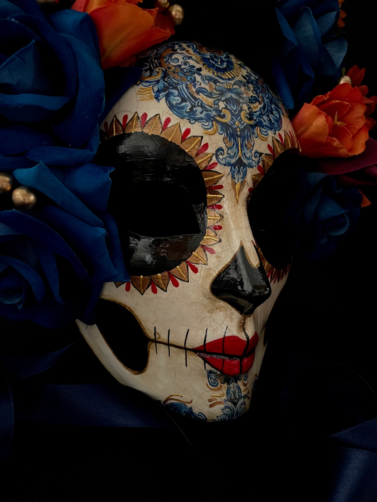 Catrina with blue and orange flowers. Day of the dead mask.