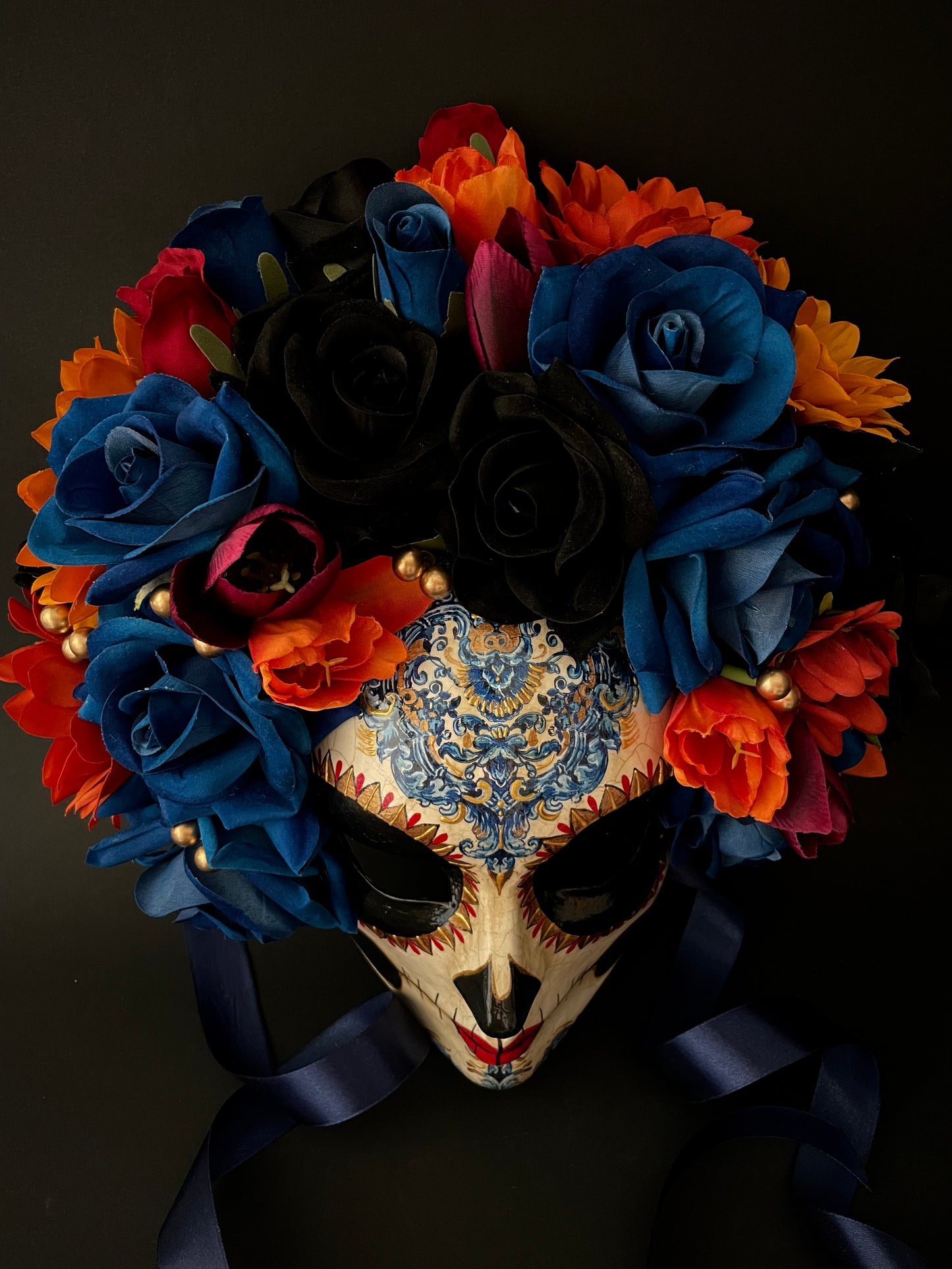 Catrina with blue and orange flowers. Day of the dead mask.