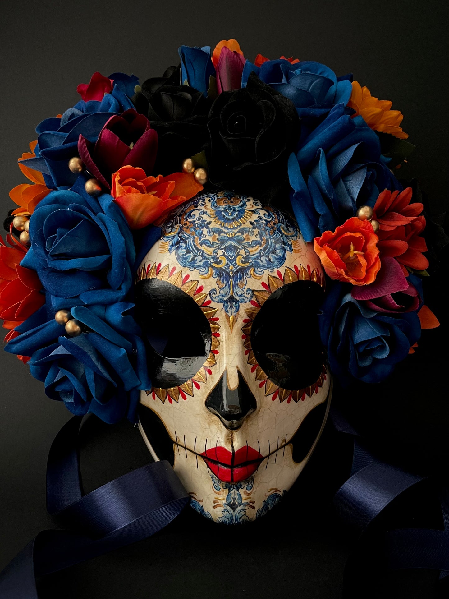 Catrina with blue and orange flowers. Day of the dead mask.