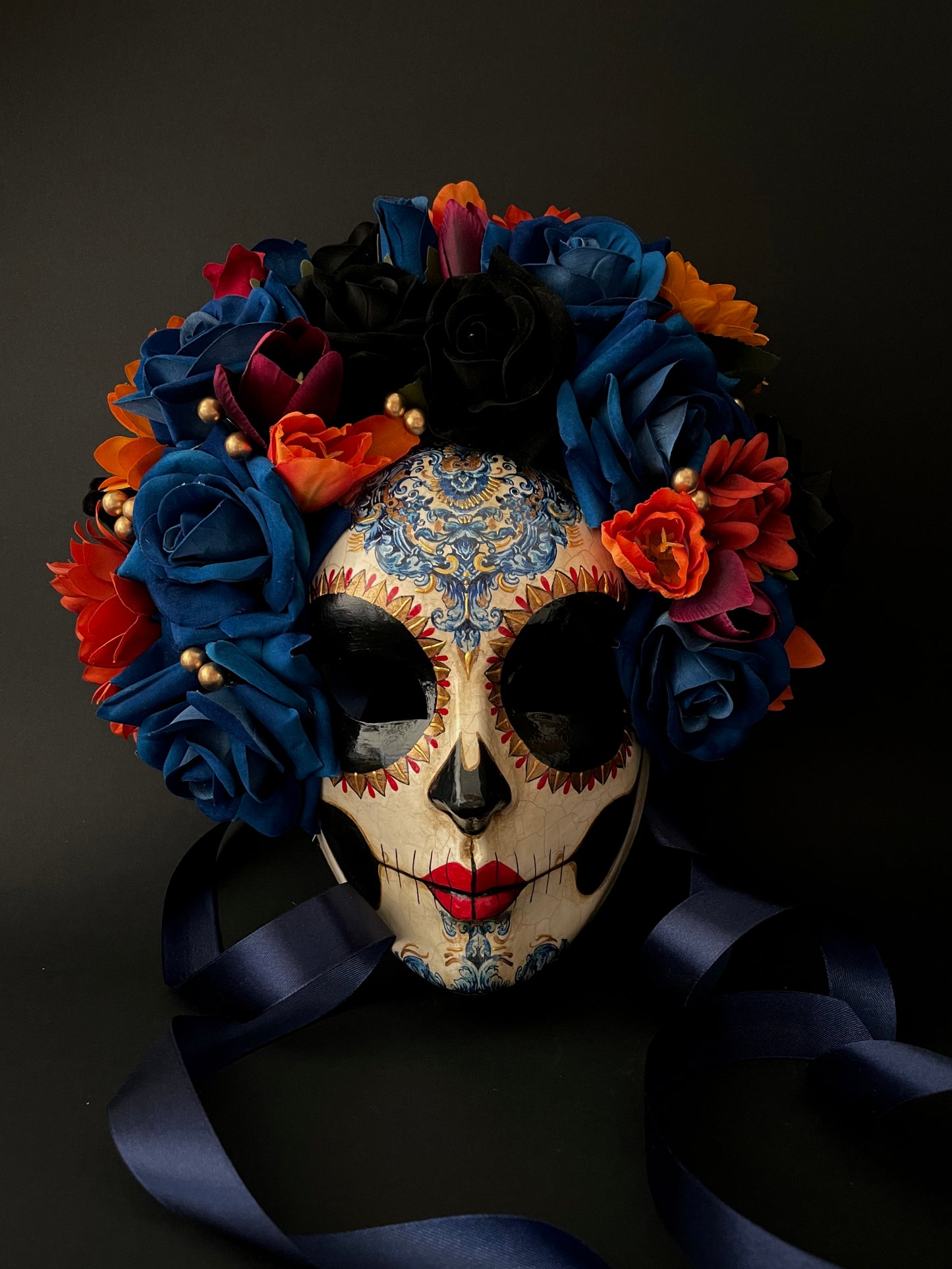 Catrina with blue and orange flowers. Day of the dead mask.