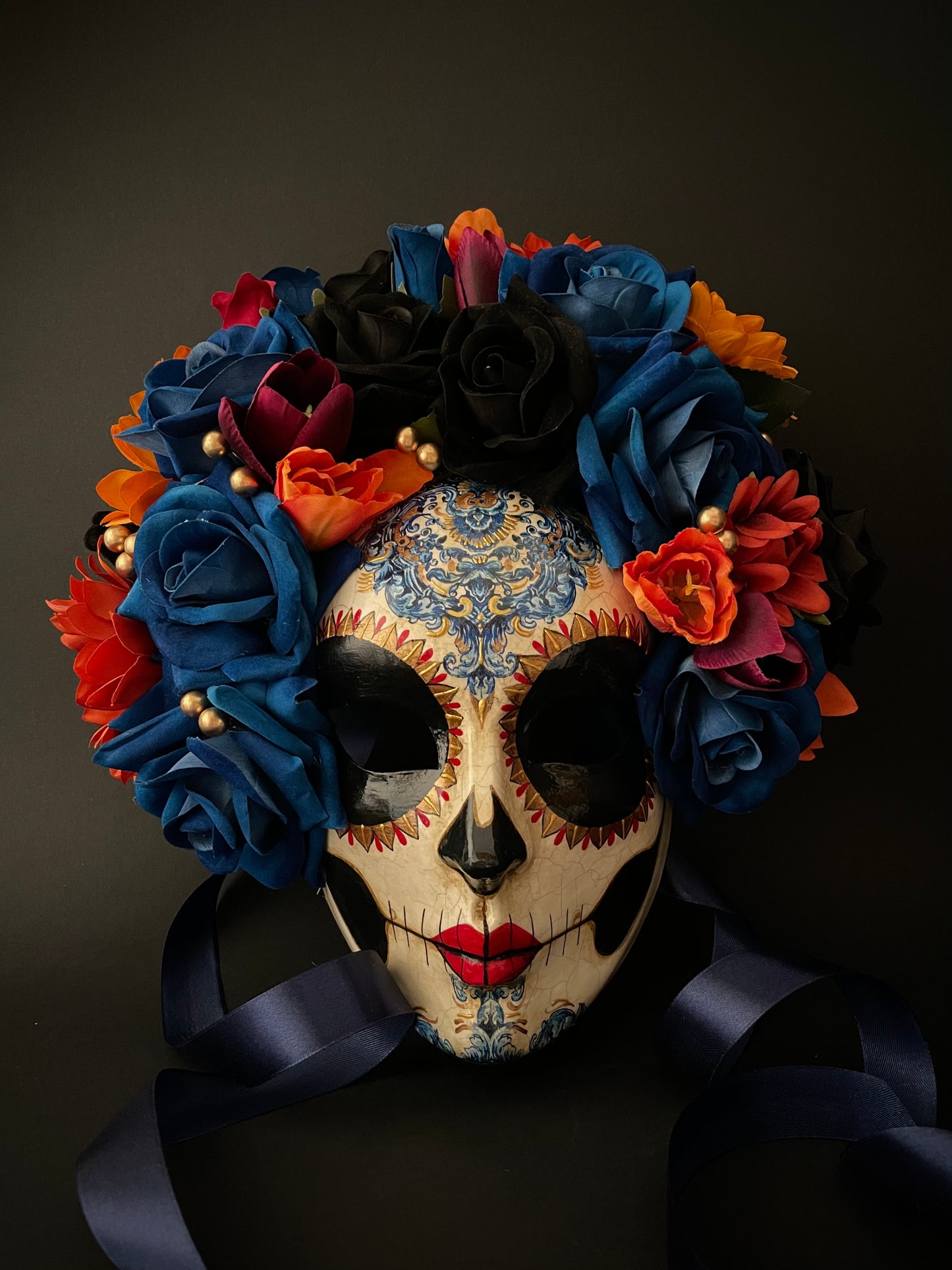 Catrina with blue and orange flowers. Day of the dead mask.