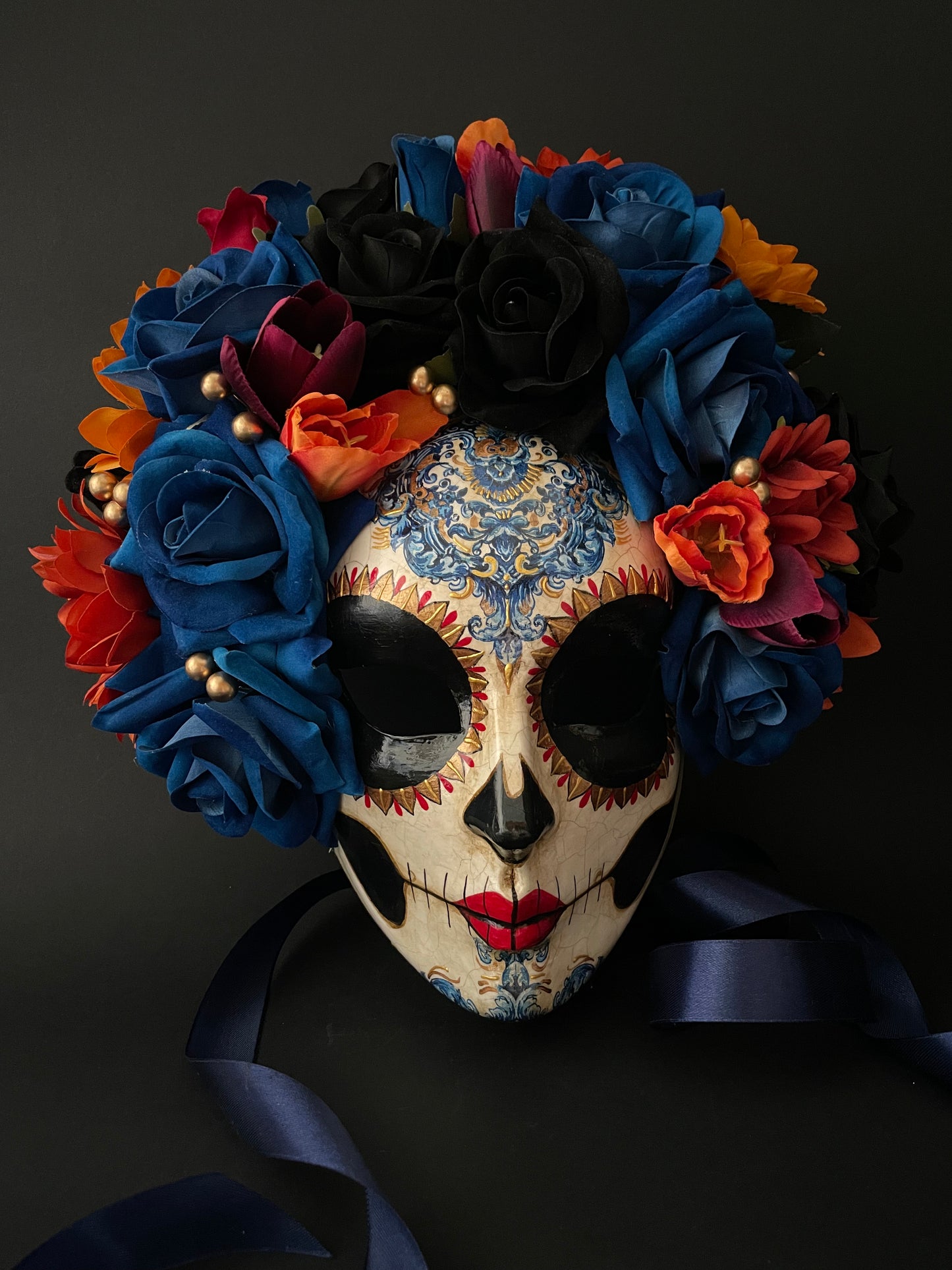 Catrina with blue and orange flowers. Day of the dead mask.