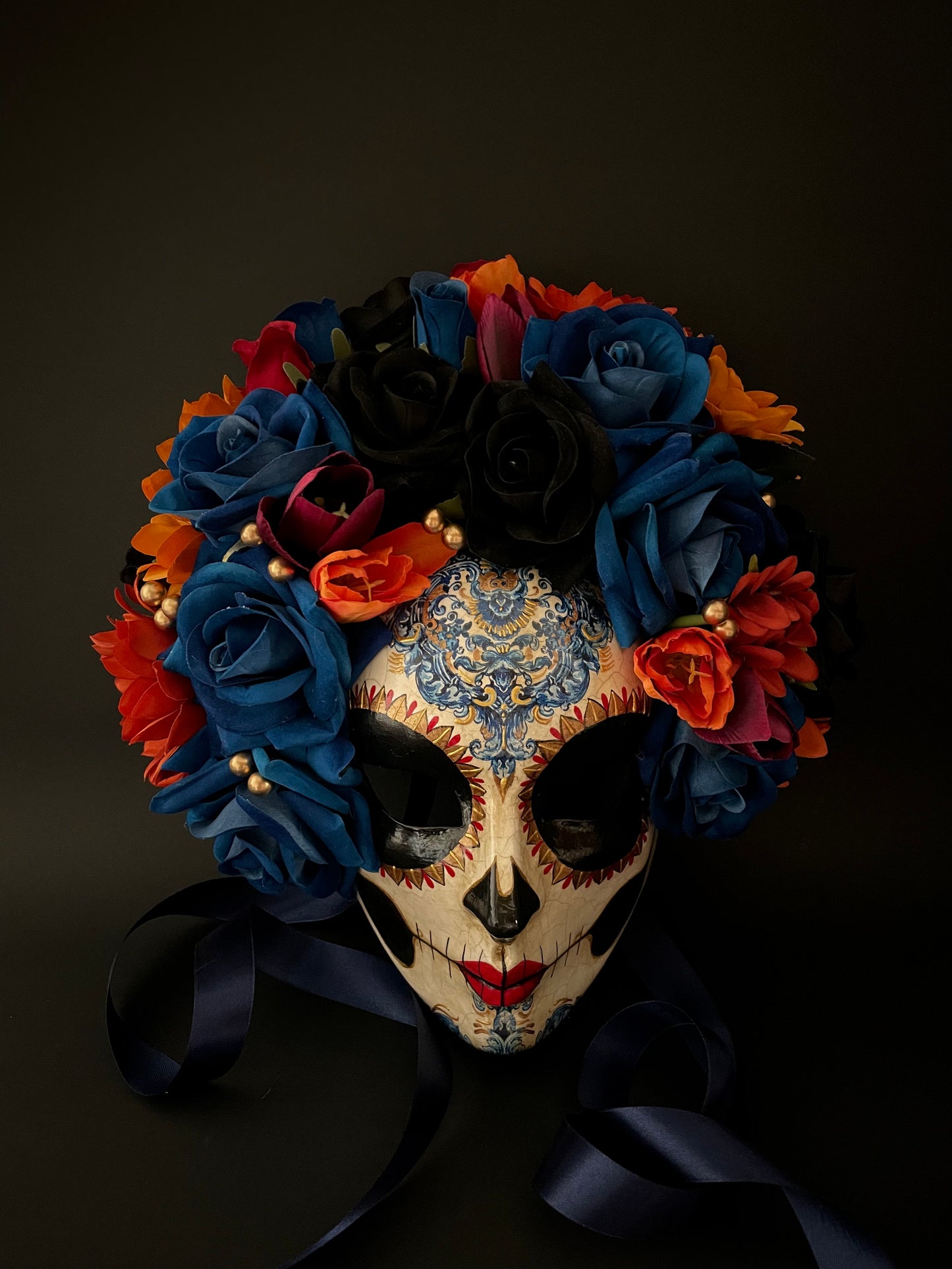 Catrina with blue and orange flowers. Day of the dead mask.