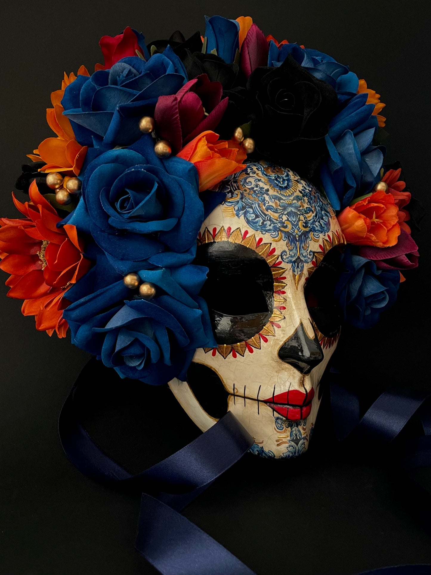 Catrina with blue and orange flowers. Day of the dead mask.