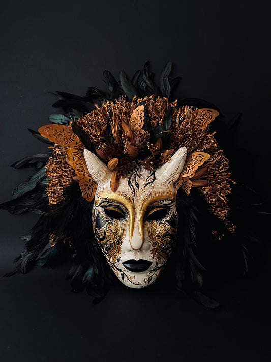 Demon mask with feathers. Masquerade mask